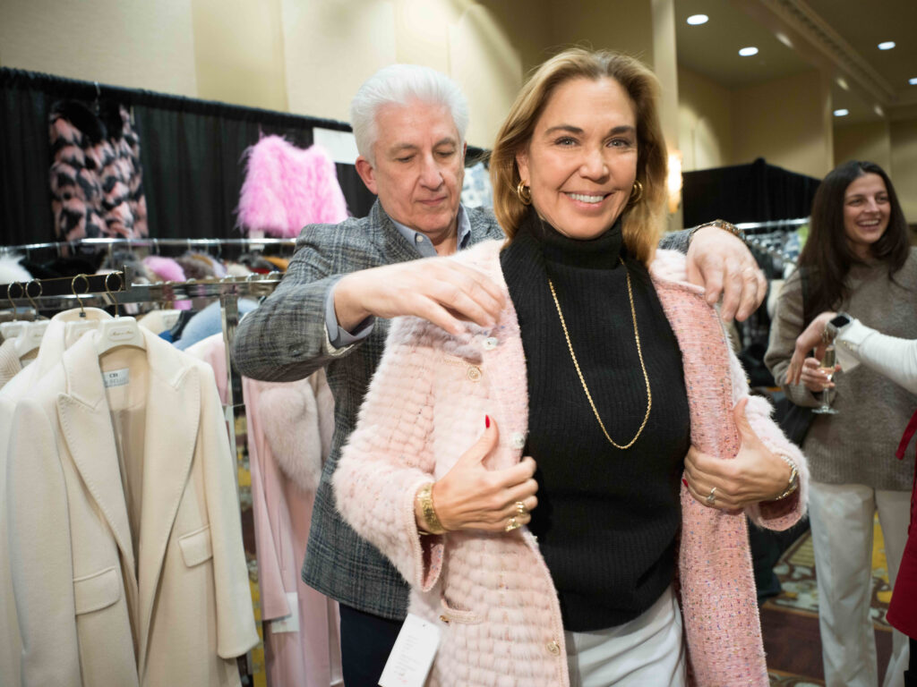Harriett Zivley enjoys a little retail therapy with Woody Nassar of Woody’s Furs during The Sale (Photo by Daniel Ortiz)