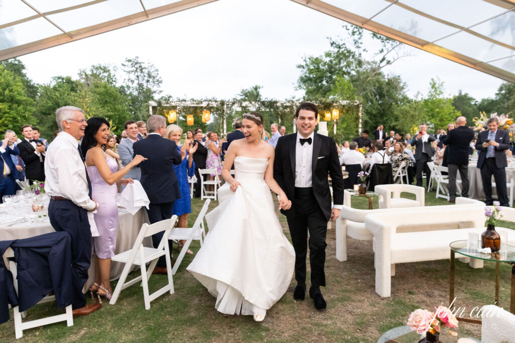 Mr. and Mrs. Books Chapman arrive at their wedding dinner, held in Memorial Park at the Clay Family Eastern Glades. (Photo by John Cain)