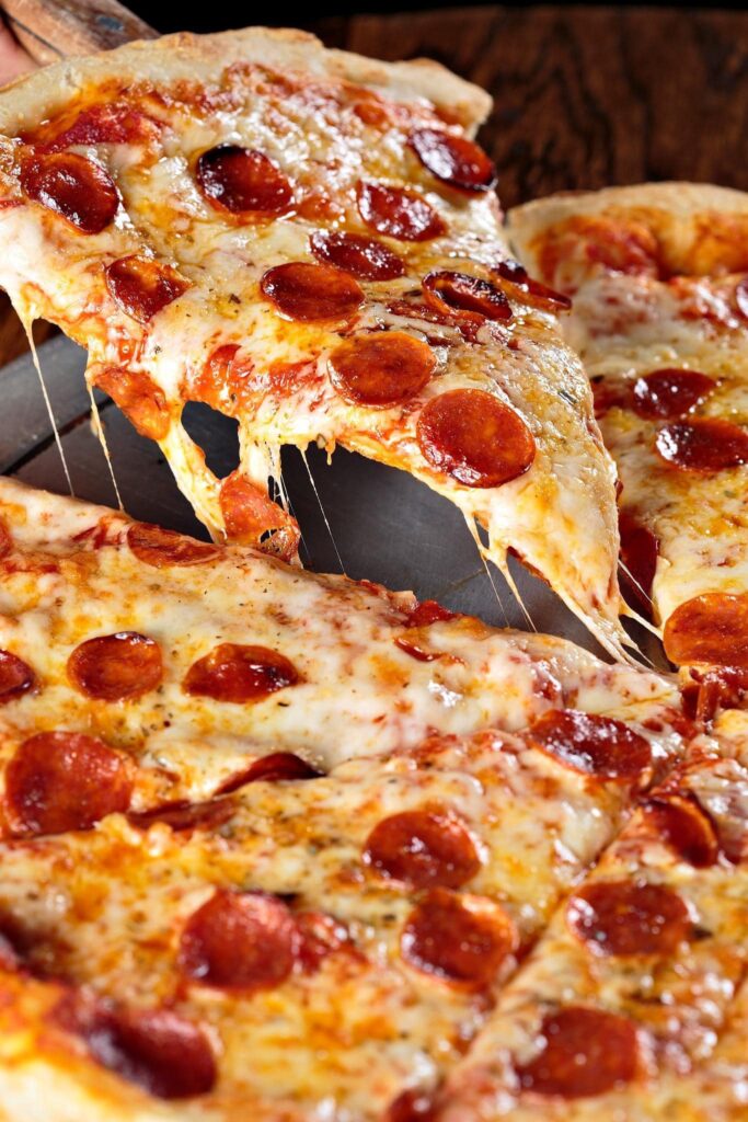 Grab pizza by the slice or whole pie alongside happy hour wings at Buffalo Bros. (Courtesy)