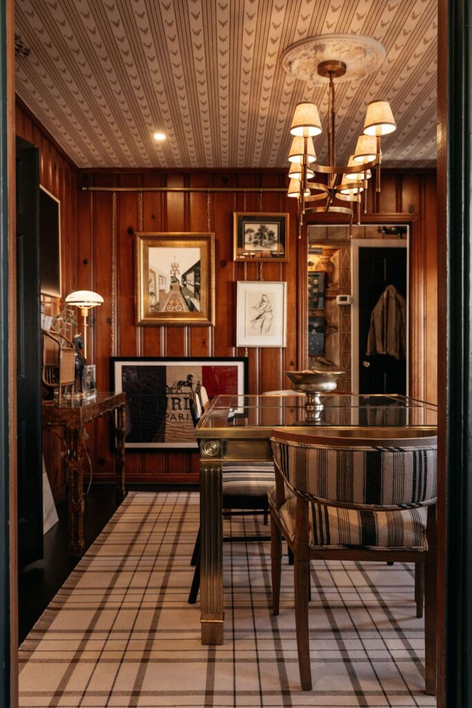 The original wood paneling remains in the den at the back of the house, and the cozy room overlooks a beautifully maintained backyard with mature landscaping and two patio areas. (Photo by Beckley)