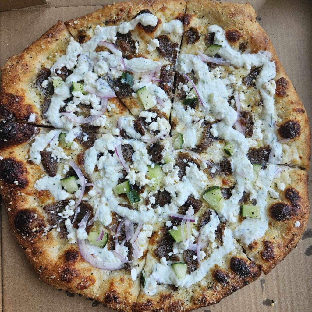 Baked Pizzeria’s pop-ups at The Black Rooster Bakery serve inventive, from-scratch pizzas like the All-American and the must-try Gyro Pizza, loaded with bold Mediterranean flavors. (Photo by Edward Brown)