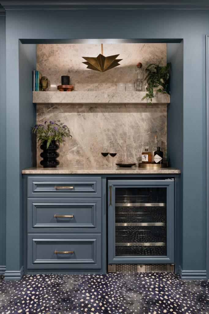 The movie room has a dedicated beverage area and a built in wine cooler.