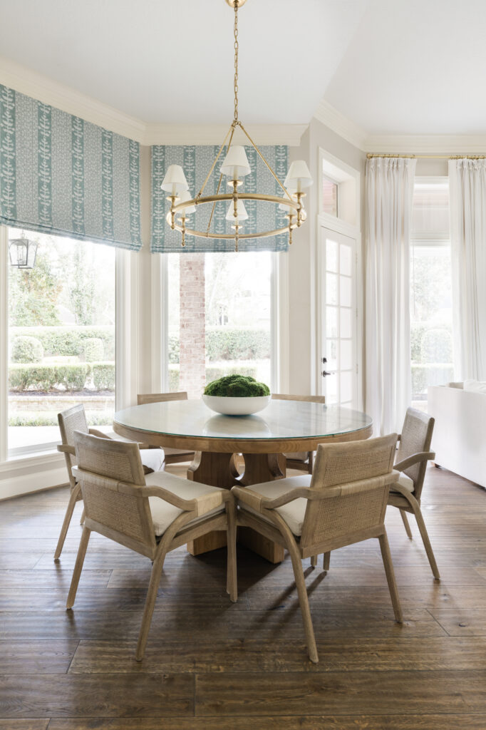 The breakfast area in the kitchen was updated with new furniture, lighting and window treatments that echo the adjacent kitchen.