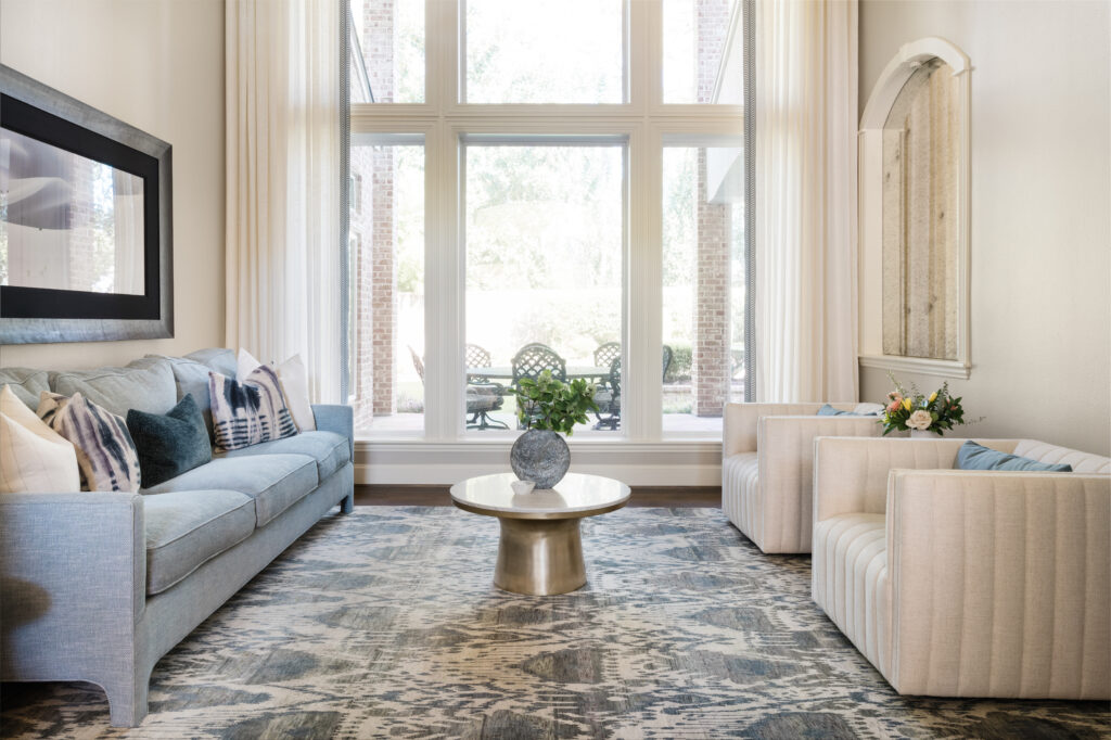 The living room has great natural light, and continues the blue color palette.