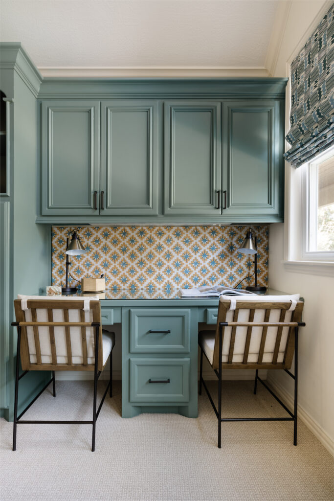 The playroom has two desk spaces for the boys, and a new fabric board beneath the cabinets comes from the JAMES showroom.