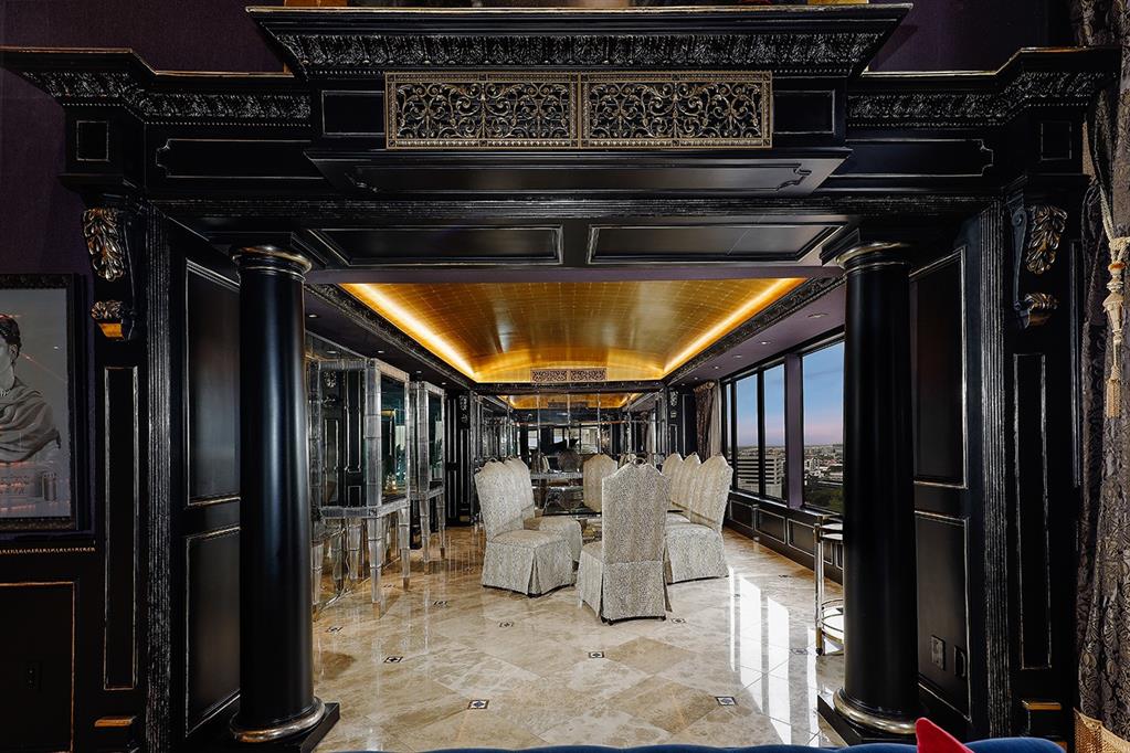 The formal dining room features a gold leaf recessed ceiling.