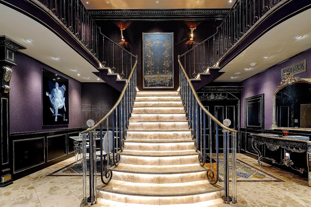 A magnificent double stairway with Baccarat crystal detailing leads to two grand bedroom suites.