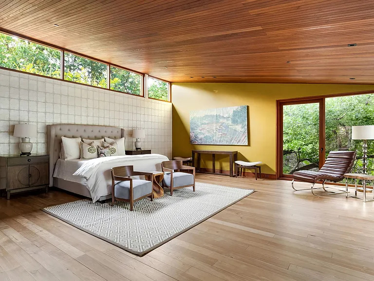 The first floor primary suite offers magnificent views of the landscape. (Photo courtesy of Allie Beth Allman & Associates)