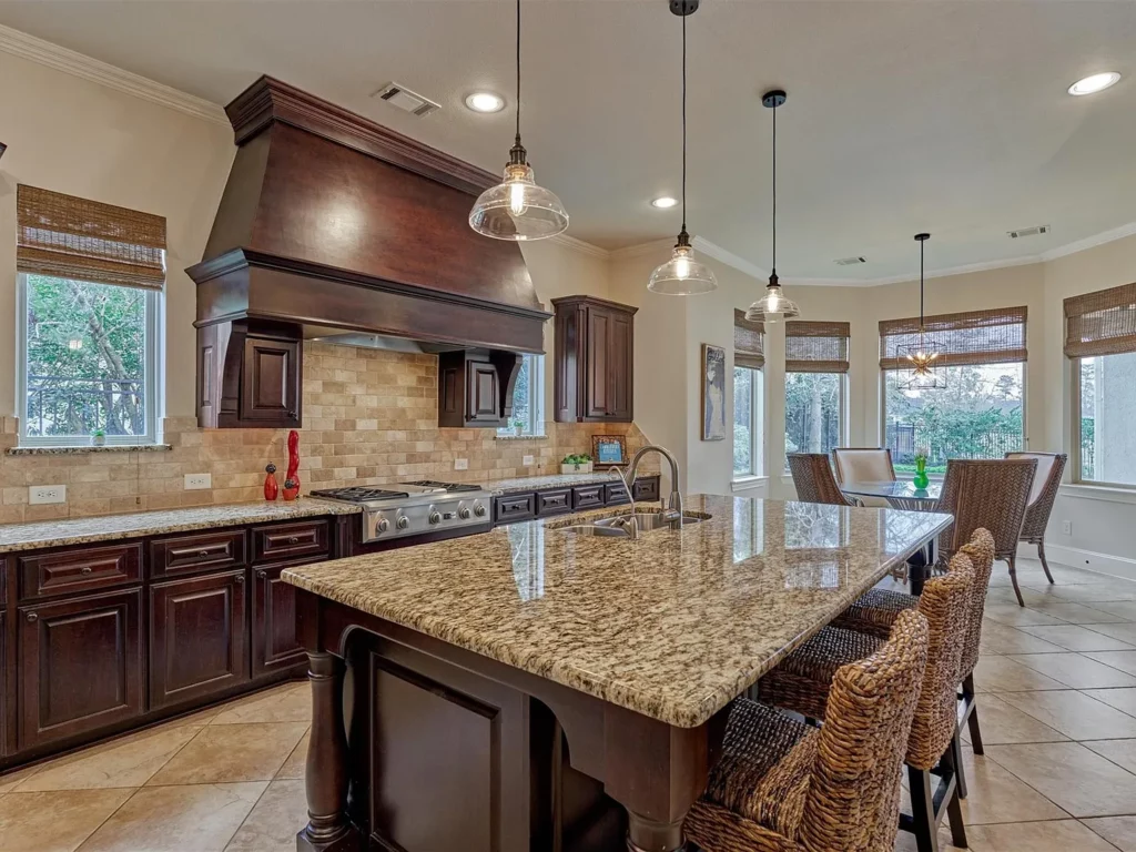 The oversized oven hood and ample countertop island at 14 N Player Manor are just two of the many features in it's immaculate kitchen. 