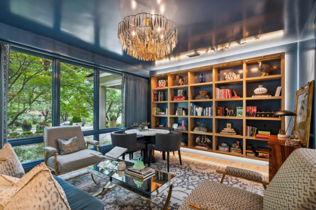 The formal dining room's dark walls and shelving create a cozy yet sophisticated vibe. (Courtesy)