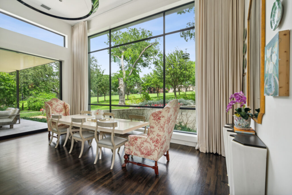 Floor-to-ceiling windows bring in light and golf course views. (Courtesy)