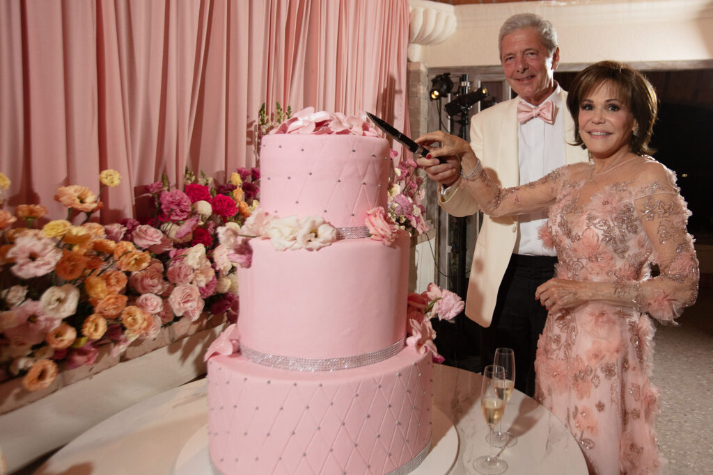 The three-tiered wedding cake was vanilla with strawberry filling, decorated with fresh flowers.  (Photo by Kara Martinez)