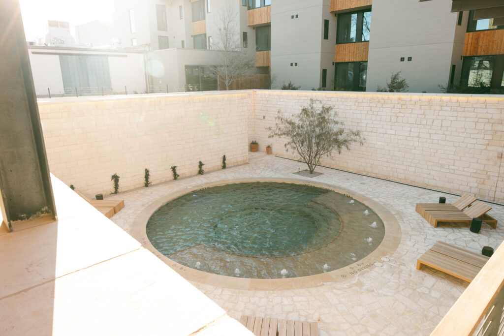 At the heart of the property lies a uniquely designed pool, sunken to evoke a classic Texas watering hole.