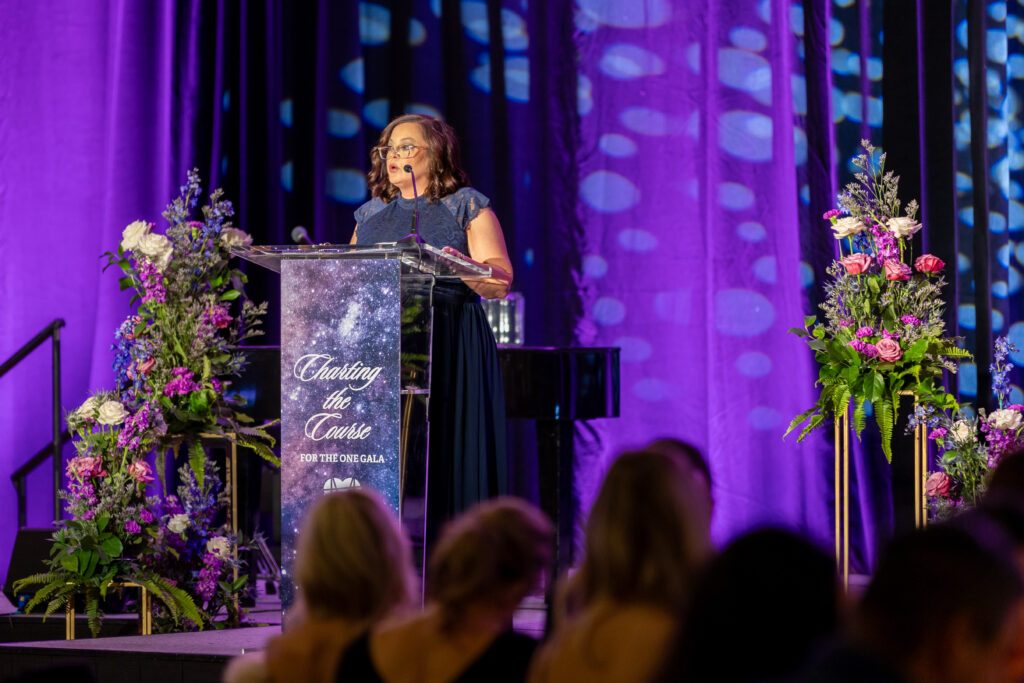 Mosaics of Mercy's Executive Director Jamie Freels-Runey shared their mission at the "For the One" gala.  (Photo courtesy of Bex Woods Photo)