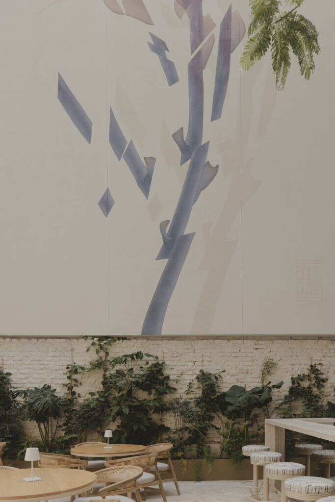 A mural by James Burrough is the focal point of the chic atrium eatery Aquiles right off the lobby of Casona Roma Norte.