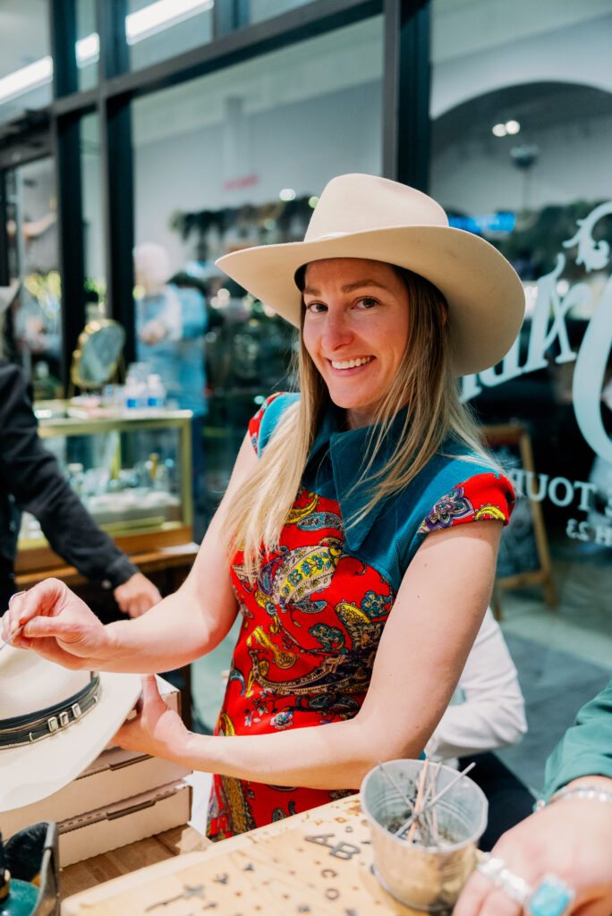 Brea Clarkson helps customize Kemo Sabe cowboy hats with personalized touches. (Photo by Nan Studios)