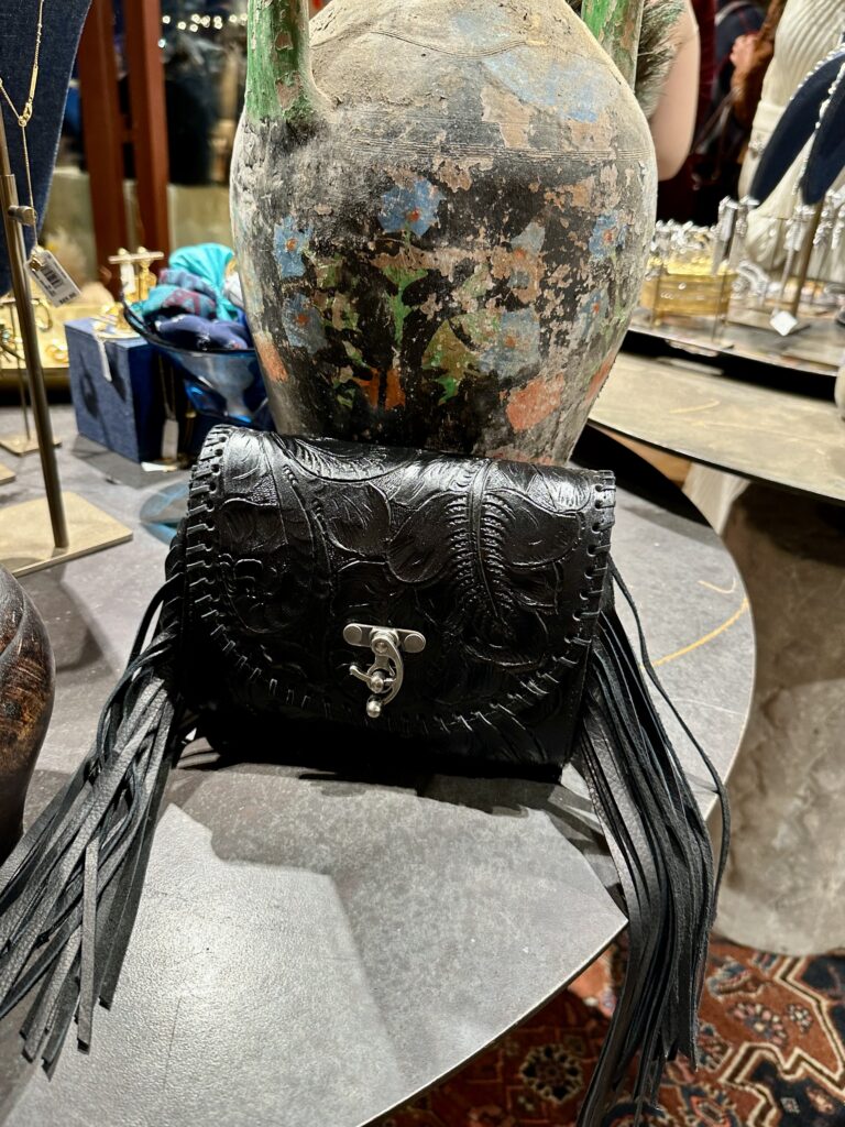 The fab leather bag available at Yellow Rose by Kendra Scott comes in a variety of rodeo ready colors. (Photo by Shelby Hodge)