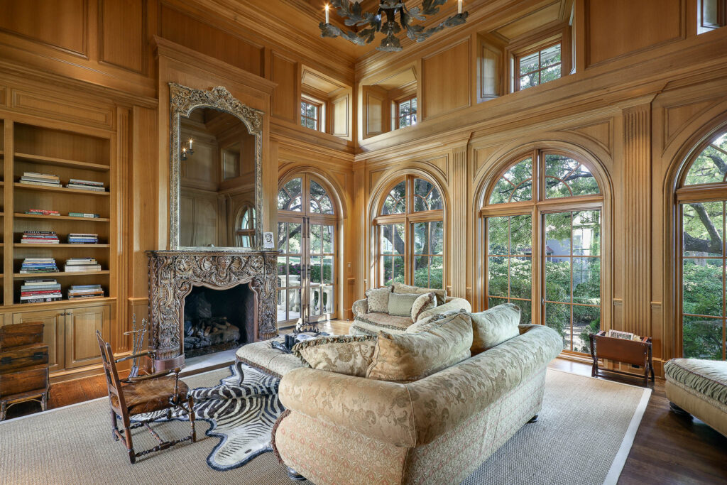 Rooms on the main floor include a library with a hand-carved fireplace. (Photo by Briggs Freeman Sotheby's International Realty)