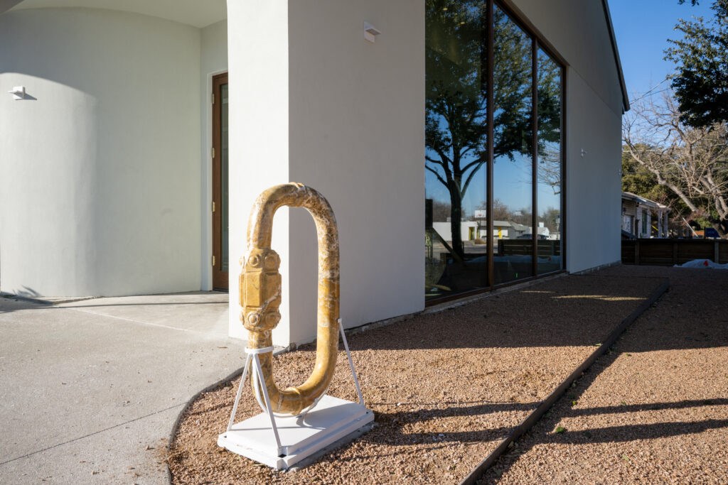 A large sculpture of a lock carved in natural stone, designed exclusively for the space, sits in front of the Lovers Lane shop. (Photo by Bruno, Snap The Picture)