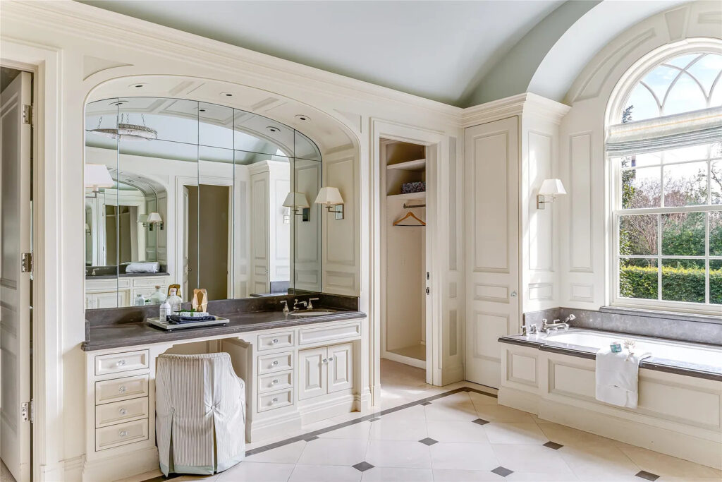The light-flooded primary bath includes dual vanities and ample space. (Photo by Allie Beth Allman & Associates)