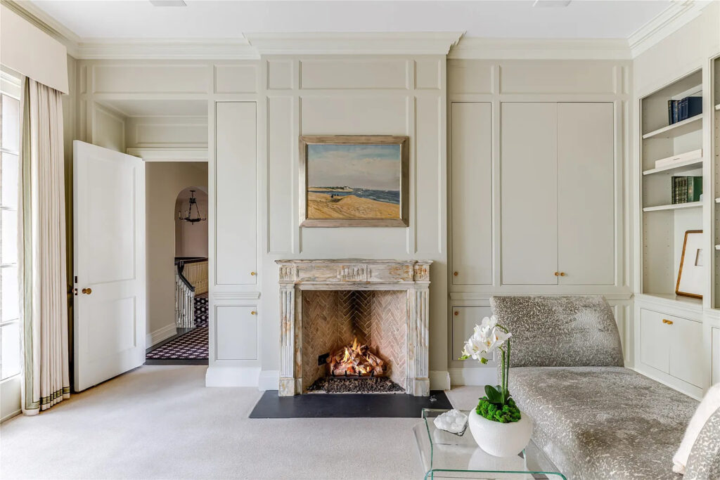 The primary bedroom's sitting area includes a fireplace. (Photo by Allie Beth Allman & Associates)
