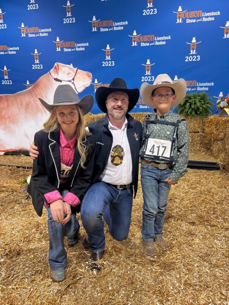 Tenenbaum Jewelers' Tony Bradfield with youngsters in the Houston Livestock Show & Rodeo steer auction.