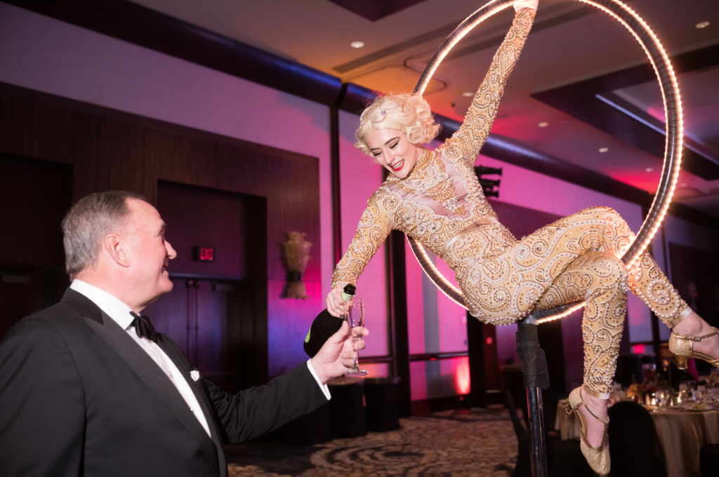 Steve Trauber receives a glass of bubbly from the champagne Hoop Girl (Photo by Daniel Ortiz)