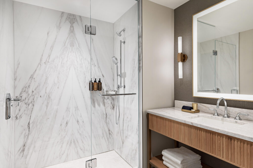 Each guest room at HALL Park Hotel offers a cozy robe and Klur bath products.