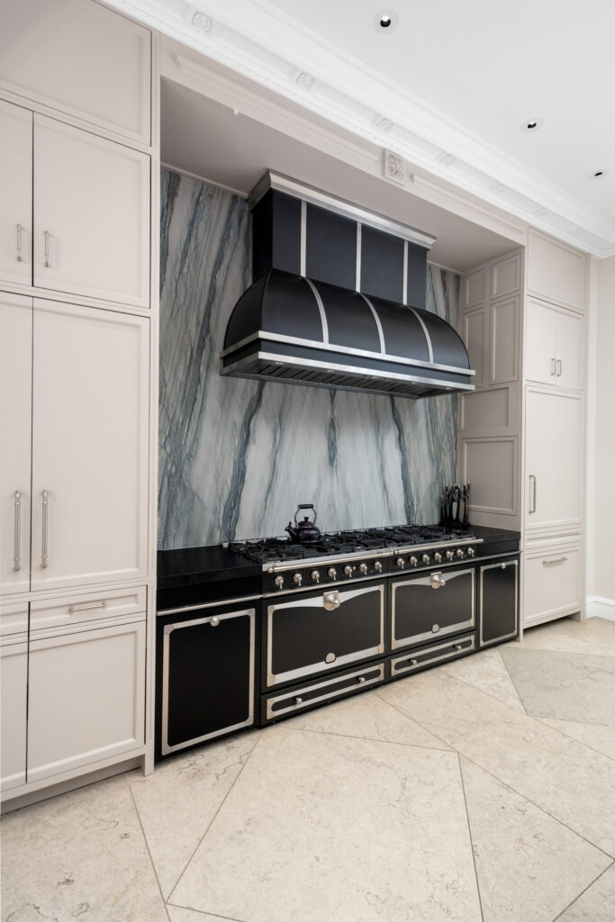 A sleek black range suits the home's elegant grandeur. (Photo by Briggs Freeman Sotheby's International Realty)