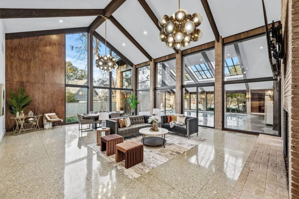 $50,000 chandeliers from Troy Lighting illuminate the grand living space and highlight its soaring, beamed ceilings. (Photo by Compass RE Texas)