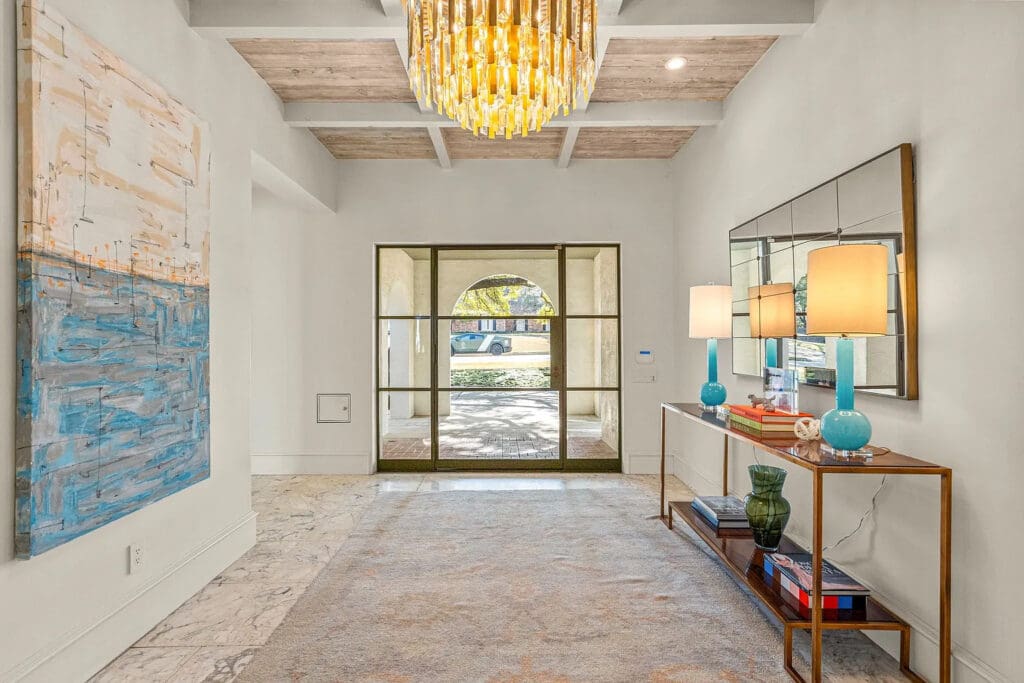 A gleaming chandelier and custom millwork set the tone for 6308 Indian Creek Drive's refined aesthetic. (Courtesy)