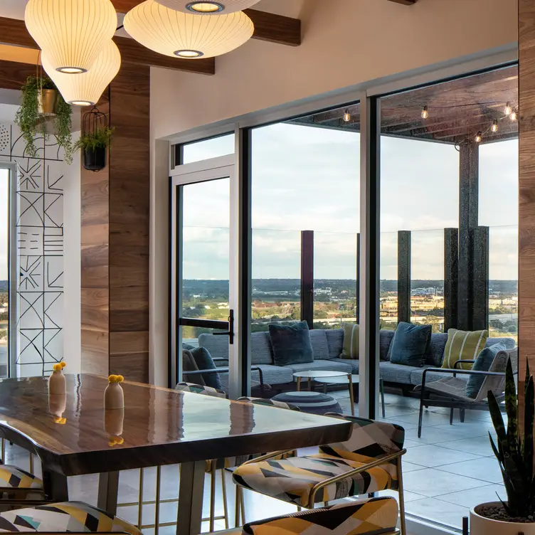 Le Méridien’s rooftop retreat offers sleek lounge seating, panoramic skyline views, and a curated small-plate menu. (Courtesy)

