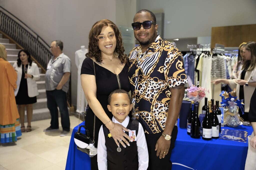 Young Adonis, a Make-A-Wish alum, and his parents at the Elizabeth Anthony kick-off for the Make-A-Wish gala (Photo by Quy Tran)