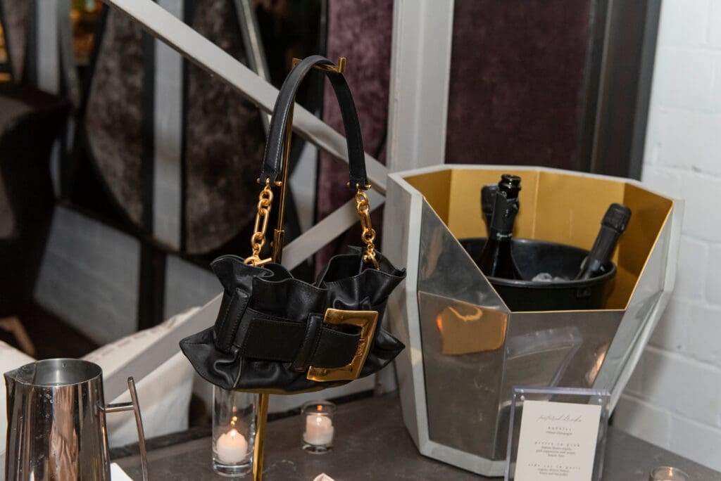 The carryall that comes in sizes ranging from mini to large (which means you’ll need more than one depending on the occasion) and priced starting around $2,000 draws inspiration from the silhouette of the hallowed houses mid-century Jolie Madame but with the drama of the line’s bold and powerful modern tailoring known for its strong shoulders. (Photo by Celeste Cass)