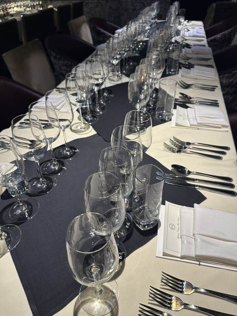 Tables at Osso & Kristalla set with scores of wine glasses for the Aperture Cellars Wine Dinner hosted by the Jim Crane family. (Photo by Shelby Hodge)