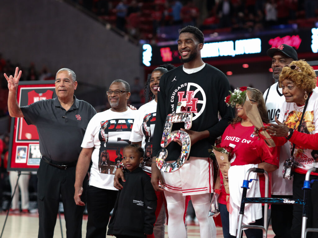 Houston coach Kelvin Sampson shares. a moment with senior center Ja'Vier Francis and Francis' family. (Photo by F. Carter Smith)