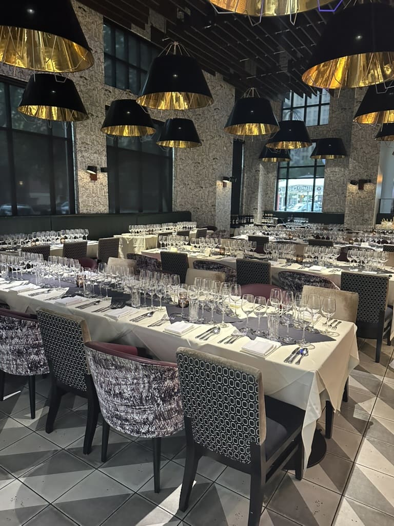 Tables at Osso & Kristilla are set for the Aperture Cellars Wine Dinner hosted by the Jim Crane family. (Photo by Shelby Hodge)