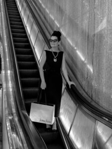 Melissa Smrekar riding the flagship’s iconic escalator. (Photo by Lorene Agather)