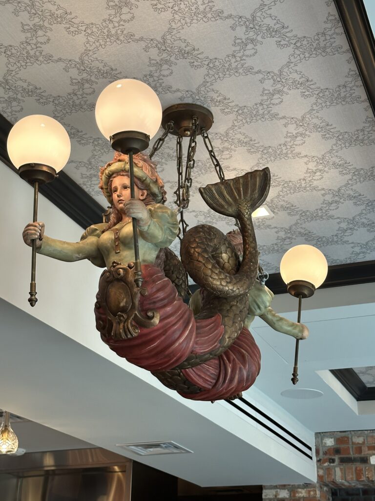 Replica figureheads from vintage sailing vessels adorn the ceiling in Brennan's Houston Courtyard Bar