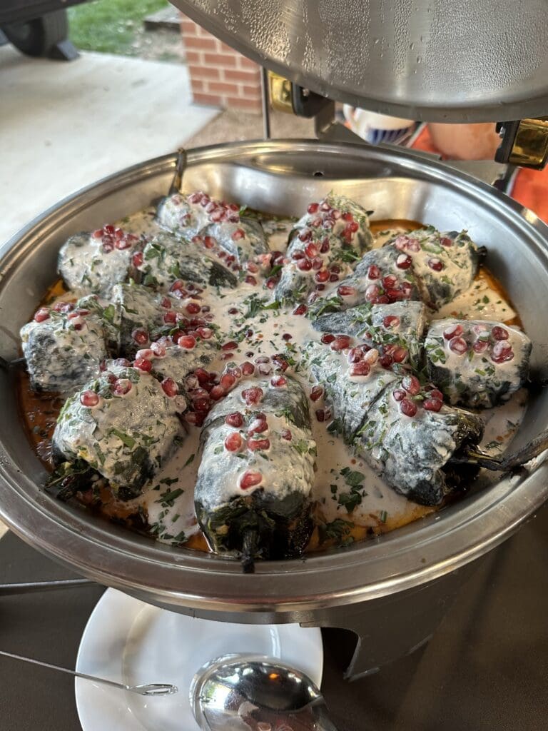 A beautiful dish of Chiles Rellenos en Nogada with pomegranate served  at The Houstonian 'Tribute to Mezcal' dinner. (Photo by Shelby Hodge)