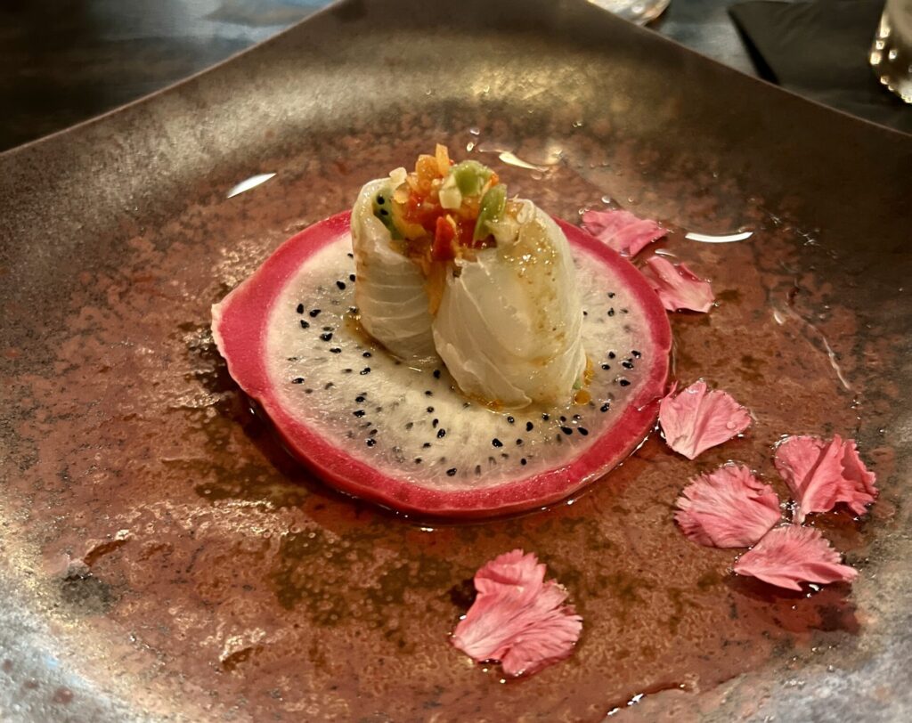 The first course of Musume's omakase dinner is the Hirame Dragon (a beautiful creation of flounder, dragon fruit, red onion amazu, and more). (Photo by Megan Ziots)
