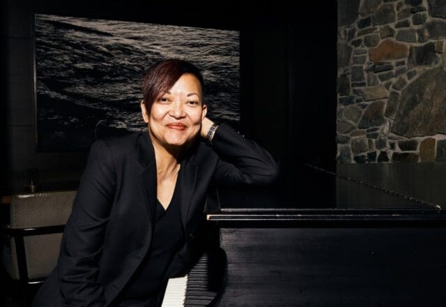 Linda Milagros Violago, the director of the wine program at Canlis, sit at the piano n the famed restaurant. (Photo by Amber Fouts)