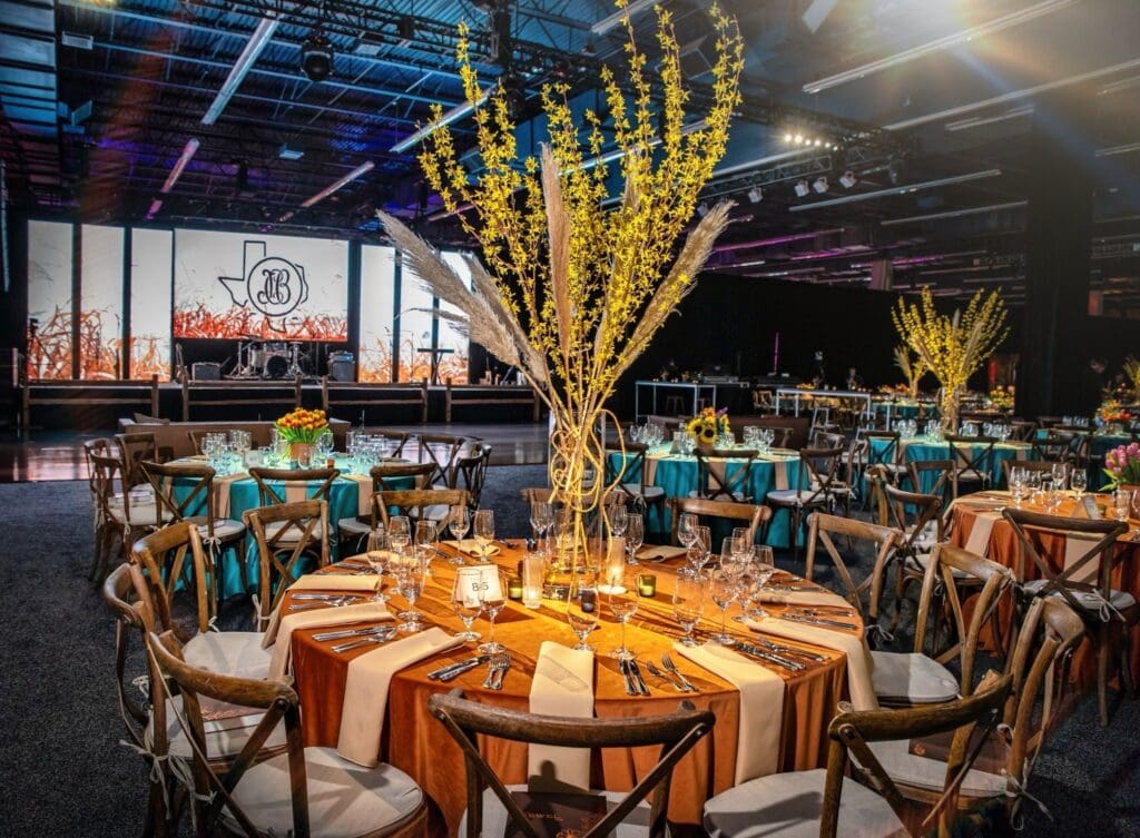 From the wooden farm tables to the wrought iron candelabras, the tablescape captured the essence of an al fresco dinner at a ranch in the Hill Country. (Photo by Rachel DeLira)