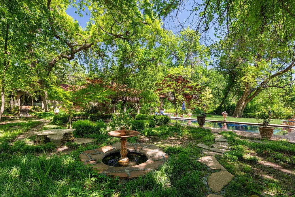 The home is enveloped by verdant grounds.  (Photo by Briggs Freeman Sotheby's International Realty)