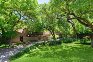 Tucked into the tranquility of Preston Hollow, greenery envelops the lot, which is bordered by a serene, gently-flowing creek. (Photo by Briggs Freeman Sotheby's International Realty)