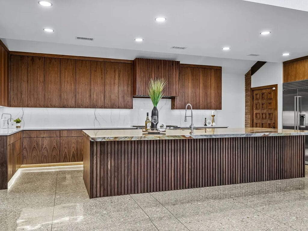 The chef's kitchen features all the modern bells and whistles — custom island, walk-in butler's pantry, and a roll call of all the fanciest appliance purveyors. (Photo by Compass RE Texas)