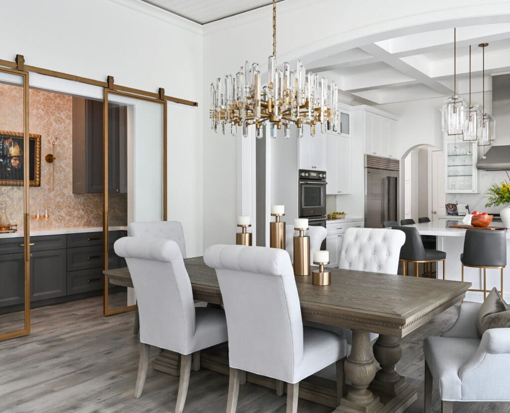 With the kitchen open to both the dining and family rooms, the space fosters easy connection for the family. (Photo by Charbonneau Interiors)