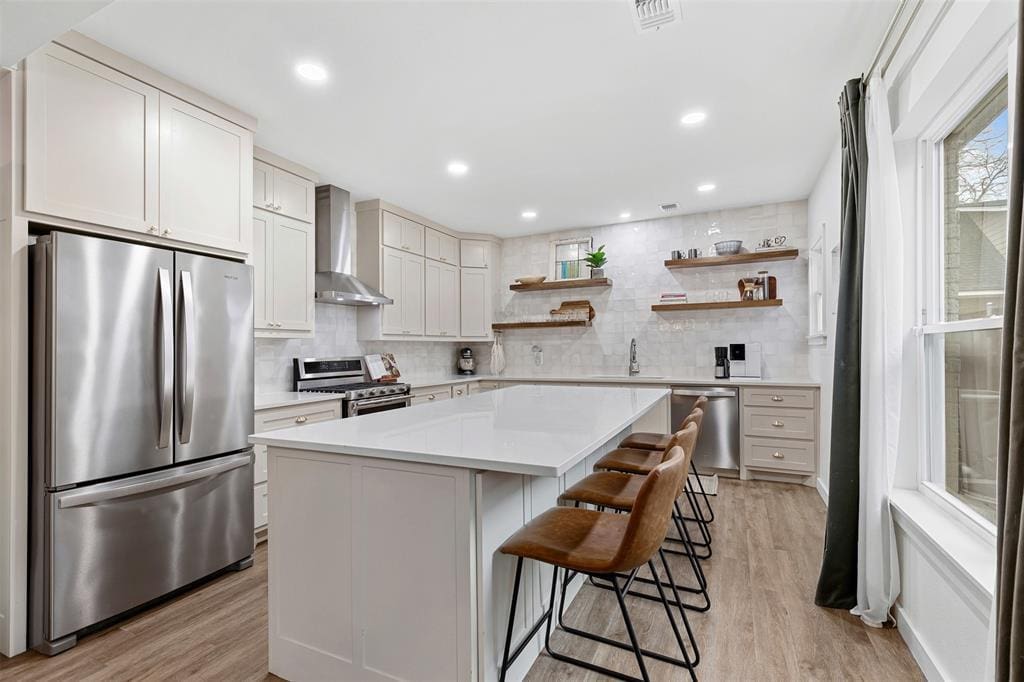 Arched entryways, custom-stained white oak floors, and extra-wide crown molding give 2712 6th Avenue timeless character while the updated kitchen features granite countertops and seating for ten. 