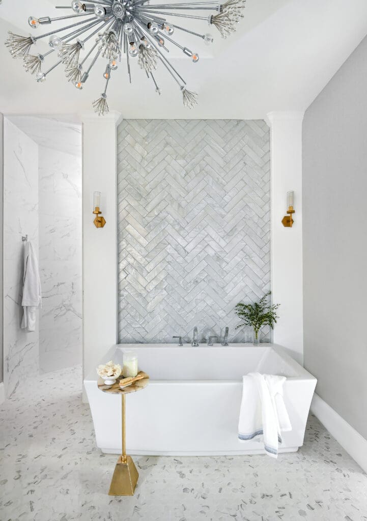 The tile insert accentuates the soaking tub, making it the star of the primary bath. (Photo by Charbonneau Interiors)