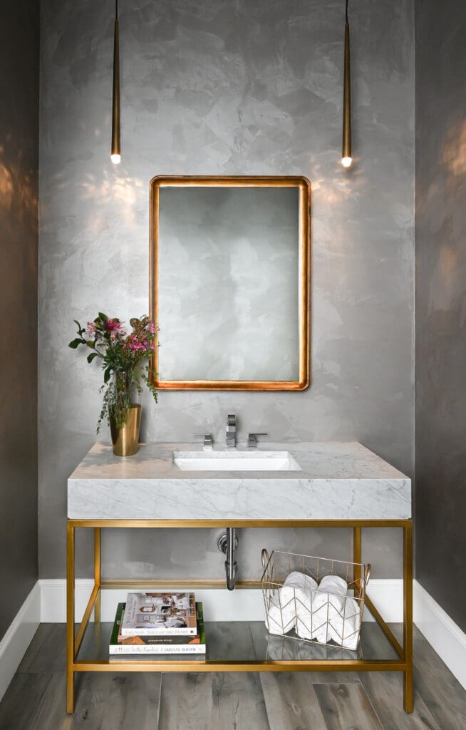 A plaster treatment adds elegant shine to the powder room walls. (Photo by Charbonneau Interiors)